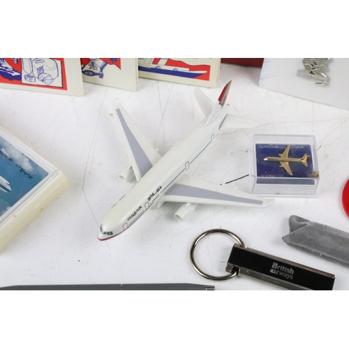 330 - A group of British Airways collectables to include badges, models, cards, games, spoons, books....et... 