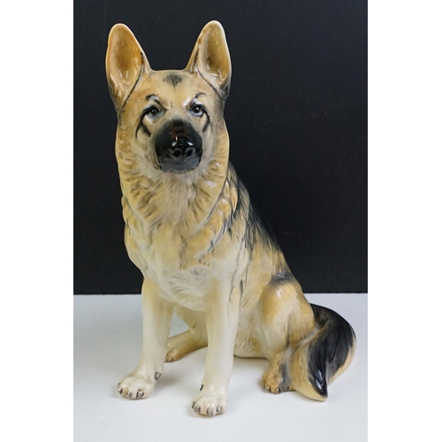 11 - Two large ceramic dogs to include a Beswick German Shepherd and an unmarked Yellow Labrador (a/f). M... 