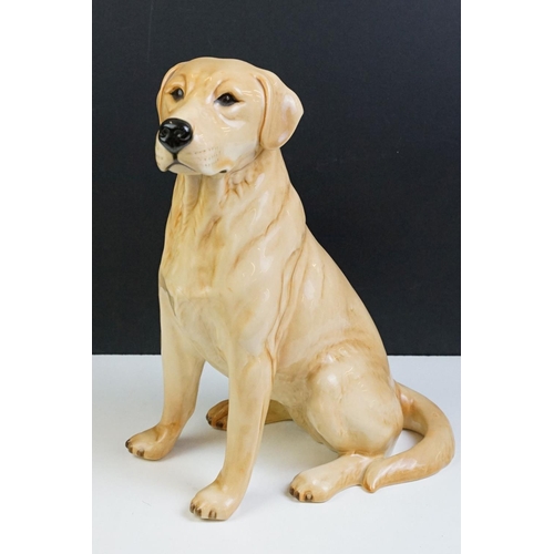 11 - Two large ceramic dogs to include a Beswick German Shepherd and an unmarked Yellow Labrador (a/f). M... 