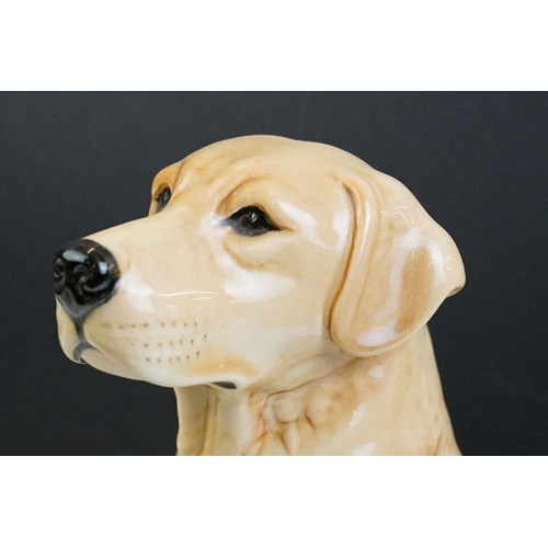 11 - Two large ceramic dogs to include a Beswick German Shepherd and an unmarked Yellow Labrador (a/f). M... 