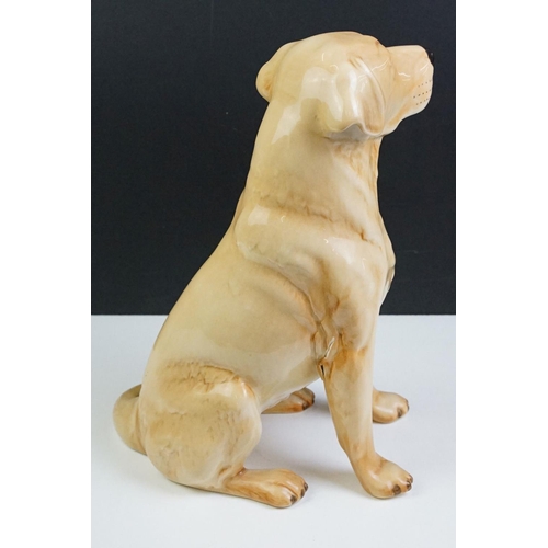 11 - Two large ceramic dogs to include a Beswick German Shepherd and an unmarked Yellow Labrador (a/f). M... 