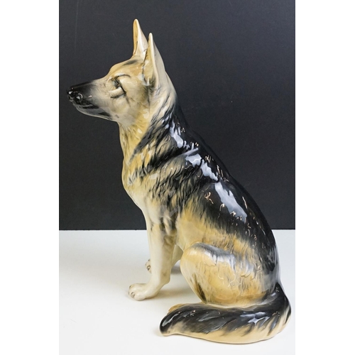 11 - Two large ceramic dogs to include a Beswick German Shepherd and an unmarked Yellow Labrador (a/f). M... 