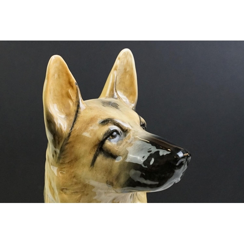 11 - Two large ceramic dogs to include a Beswick German Shepherd and an unmarked Yellow Labrador (a/f). M... 