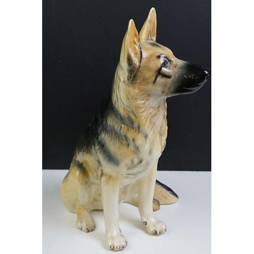 11 - Two large ceramic dogs to include a Beswick German Shepherd and an unmarked Yellow Labrador (a/f). M... 