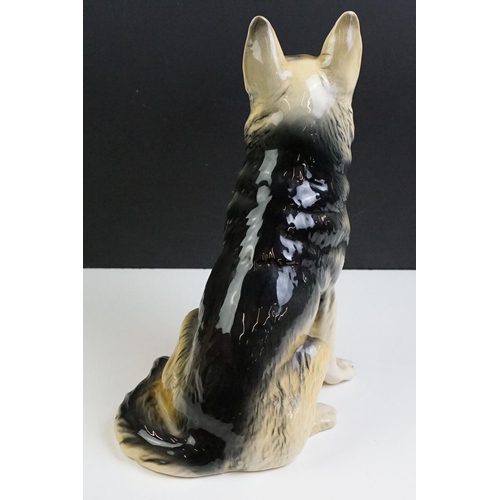 11 - Two large ceramic dogs to include a Beswick German Shepherd and an unmarked Yellow Labrador (a/f). M... 