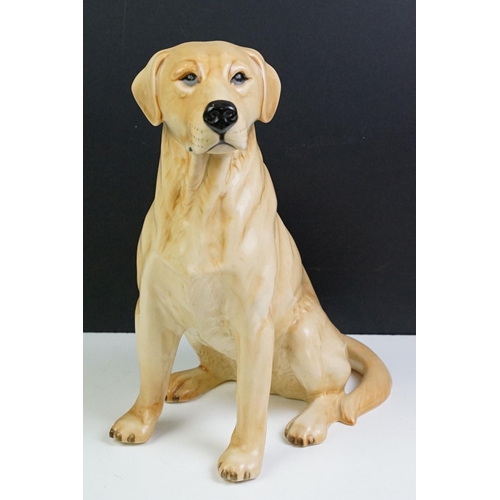 11 - Two large ceramic dogs to include a Beswick German Shepherd and an unmarked Yellow Labrador (a/f). M... 