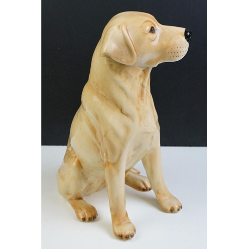 11 - Two large ceramic dogs to include a Beswick German Shepherd and an unmarked Yellow Labrador (a/f). M... 