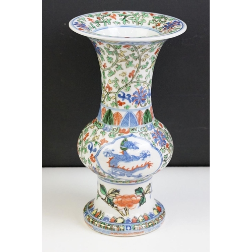 16 - Chinese porcelain gu vase having blue underglaze detailing featuring a dragon with green, red and ye... 