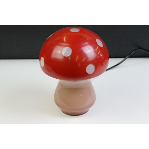 22 - Glass toadstool mushroom lamp having a pink glass base with red painted shade. Measures approx 21cm ... 