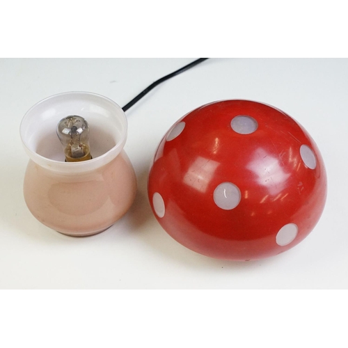 22 - Glass toadstool mushroom lamp having a pink glass base with red painted shade. Measures approx 21cm ... 