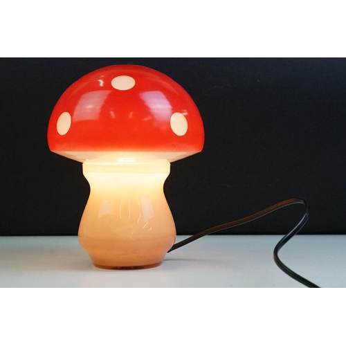 22 - Glass toadstool mushroom lamp having a pink glass base with red painted shade. Measures approx 21cm ... 