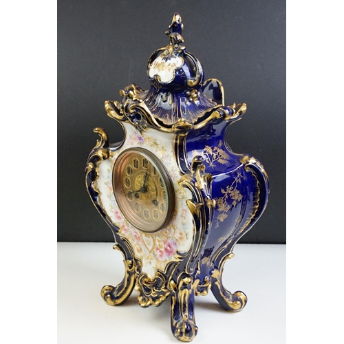 23 - Ceramic mantle clock having moulded scrolled acanthus leaf detailing with floral detailing, and roun... 