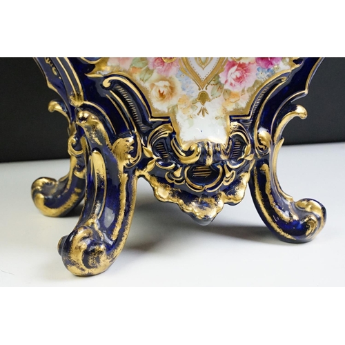 23 - Ceramic mantle clock having moulded scrolled acanthus leaf detailing with floral detailing, and roun... 