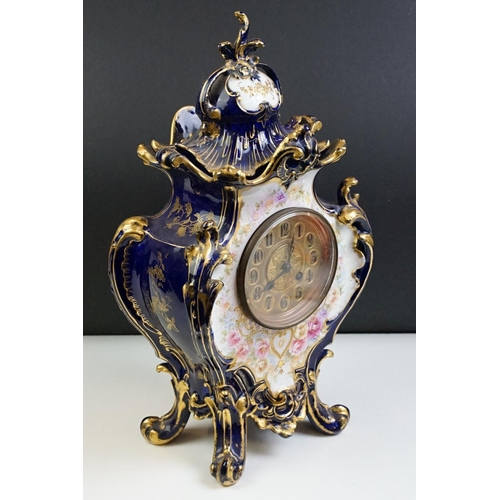 23 - Ceramic mantle clock having moulded scrolled acanthus leaf detailing with floral detailing, and roun... 