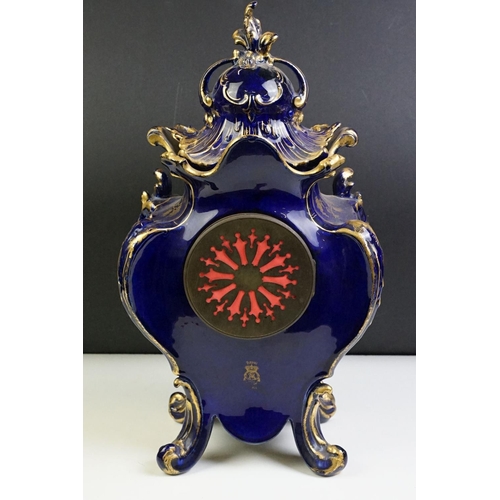 23 - Ceramic mantle clock having moulded scrolled acanthus leaf detailing with floral detailing, and roun... 