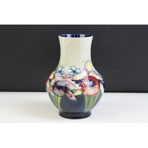 24 - Moorcroft Orchid pattern small baluster vase with tube lined detailing. Impressed Moorcroft mark to ... 