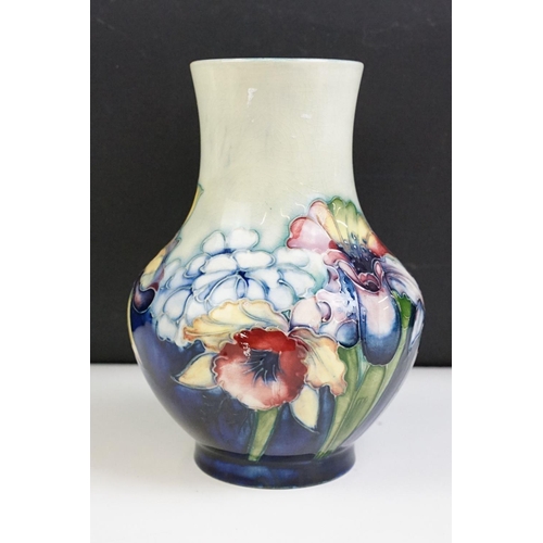 24 - Moorcroft Orchid pattern small baluster vase with tube lined detailing. Impressed Moorcroft mark to ... 