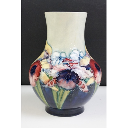 24 - Moorcroft Orchid pattern small baluster vase with tube lined detailing. Impressed Moorcroft mark to ... 