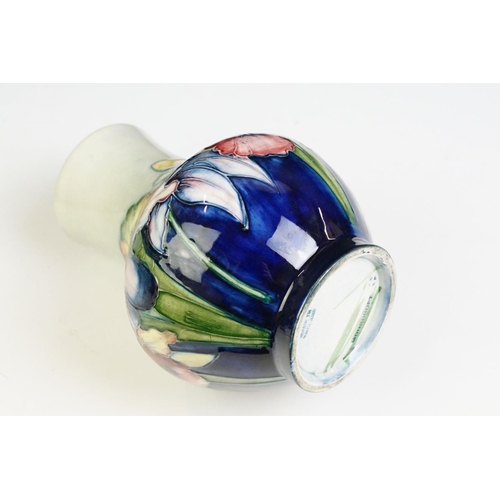 24 - Moorcroft Orchid pattern small baluster vase with tube lined detailing. Impressed Moorcroft mark to ... 