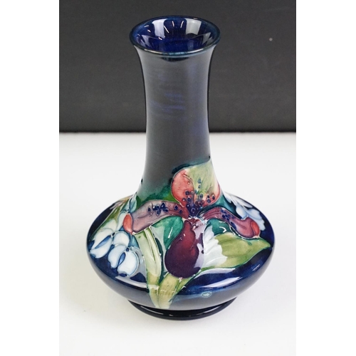 25 - Moorcroft Orchid pattern vase having a blue ground with tube lined floral detailing. Impressed marks... 