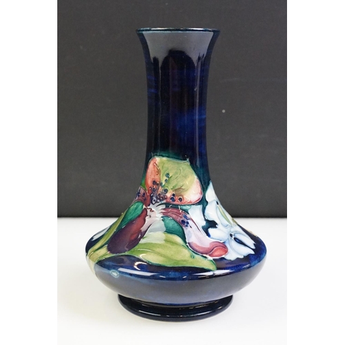 25 - Moorcroft Orchid pattern vase having a blue ground with tube lined floral detailing. Impressed marks... 