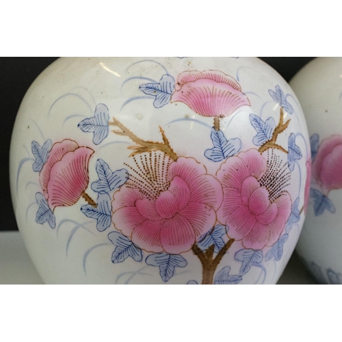 26 - Pair of Chinese large ginger jars, each having printed pink and blue floral designs. Blue seal marks... 