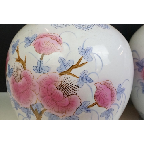 26 - Pair of Chinese large ginger jars, each having printed pink and blue floral designs. Blue seal marks... 