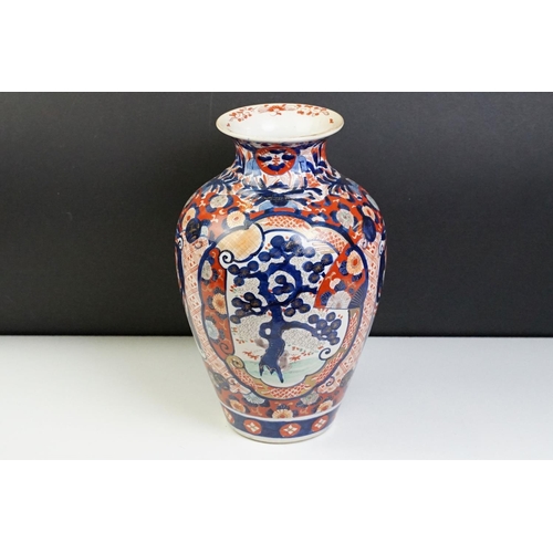 39 - Japanese Imari baluster vase having blue and white underglaze detailing and red and gilt over painte... 