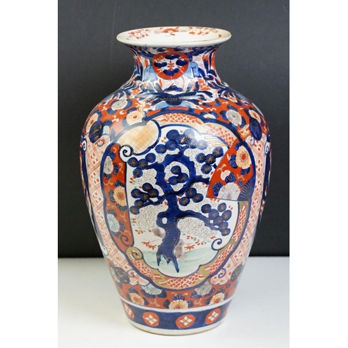 39 - Japanese Imari baluster vase having blue and white underglaze detailing and red and gilt over painte... 