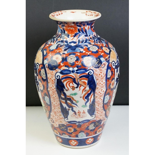 39 - Japanese Imari baluster vase having blue and white underglaze detailing and red and gilt over painte... 