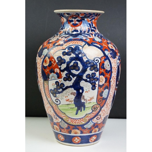 39 - Japanese Imari baluster vase having blue and white underglaze detailing and red and gilt over painte... 