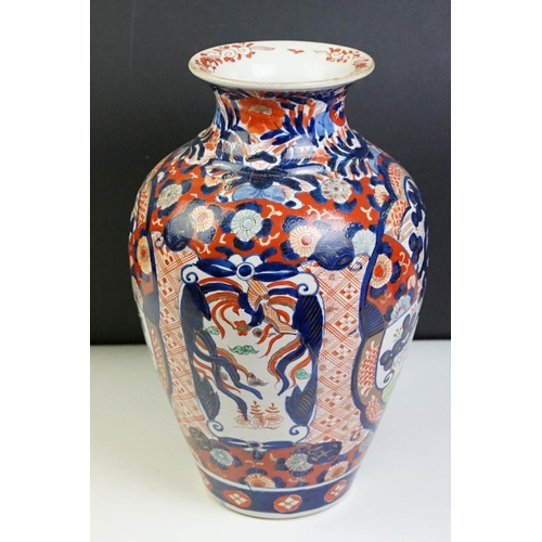 39 - Japanese Imari baluster vase having blue and white underglaze detailing and red and gilt over painte... 