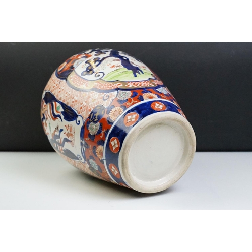 39 - Japanese Imari baluster vase having blue and white underglaze detailing and red and gilt over painte... 