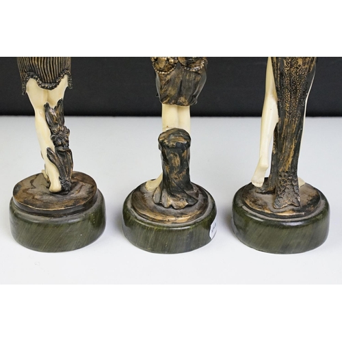 41 - Three Art Deco style resin figures in the form of women in matching costumes. Measures 22cm tall.