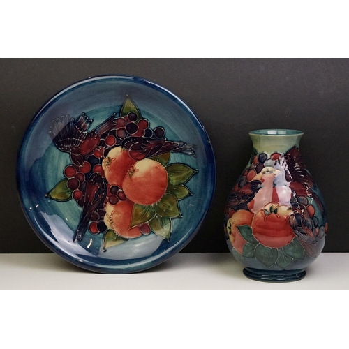 5 - Moorcroft Finches and Fruit pattern plate together with a baluster vase, both with tube lined detail... 