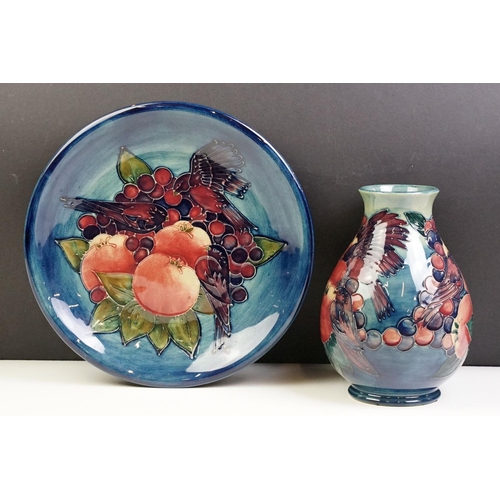 5 - Moorcroft Finches and Fruit pattern plate together with a baluster vase, both with tube lined detail... 