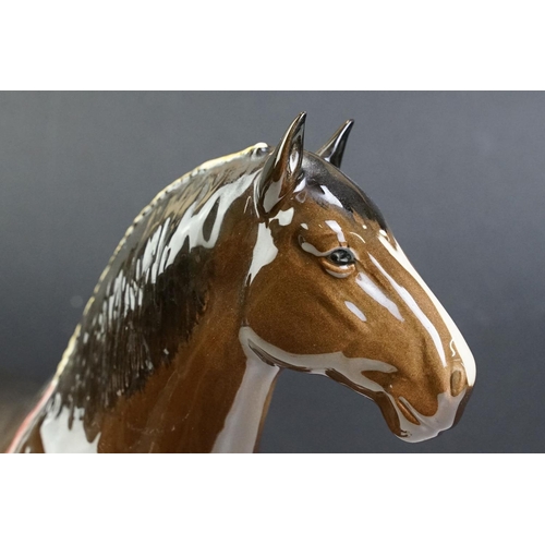 51 - Two Beswick horses to include a white footed shire horse together with a black and white appaloosa s... 