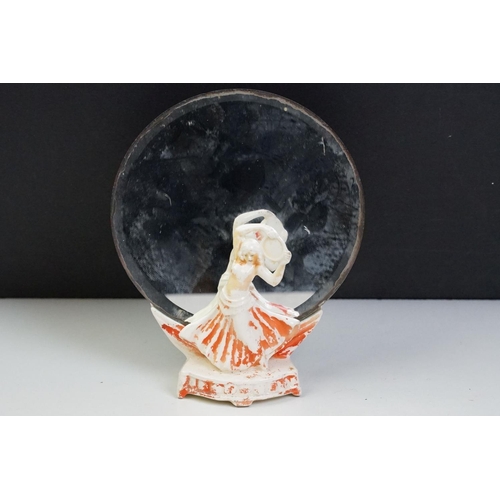 57 - Pair of Art Deco ceramic mirror stands in the form of belly dancers, each holding a round bevelled g... 