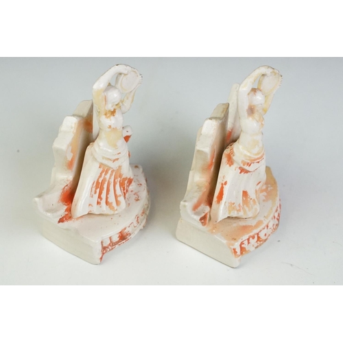 57 - Pair of Art Deco ceramic mirror stands in the form of belly dancers, each holding a round bevelled g... 