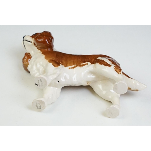 58 - Group of Beswick ceramic dog figurines to include three poodles, a corgi, cavalier king charles span... 