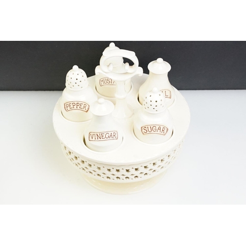 66 - Large Leeds creamware cruet set, the stand with a band of geometric piercing, impressed mark to base... 