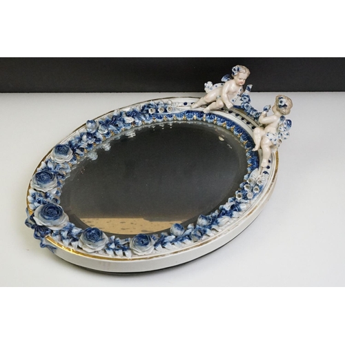 67 - Sitzendorf porcelain dressing table mirror with blue & white floral encrusting, putti with garland t... 