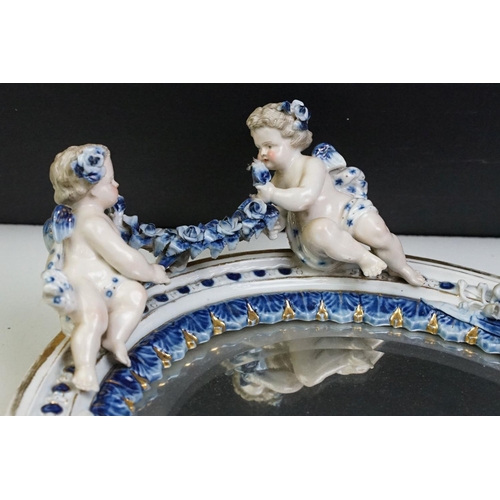 67 - Sitzendorf porcelain dressing table mirror with blue & white floral encrusting, putti with garland t... 