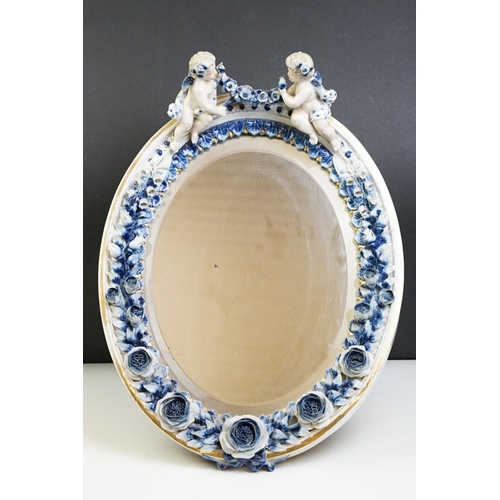 67 - Sitzendorf porcelain dressing table mirror with blue & white floral encrusting, putti with garland t... 