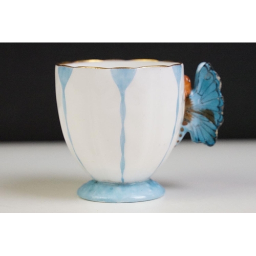 6A - Aynsley Art Deco tea cup and saucer having a butterfly formed handle, gilt rims and blue hand painte... 