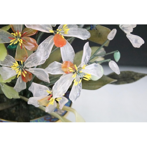 160 - Chinese Hardstone Flower held in a Cloisonne Bowl decorated with flowers on a blue ground, 43cm high