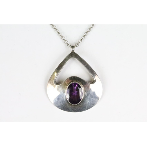 205 - A 925 sterling silver modernist pendant with faceted amethyst centre stone mounted to 925 sterling s... 