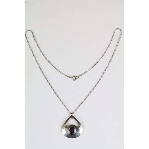 205 - A 925 sterling silver modernist pendant with faceted amethyst centre stone mounted to 925 sterling s... 