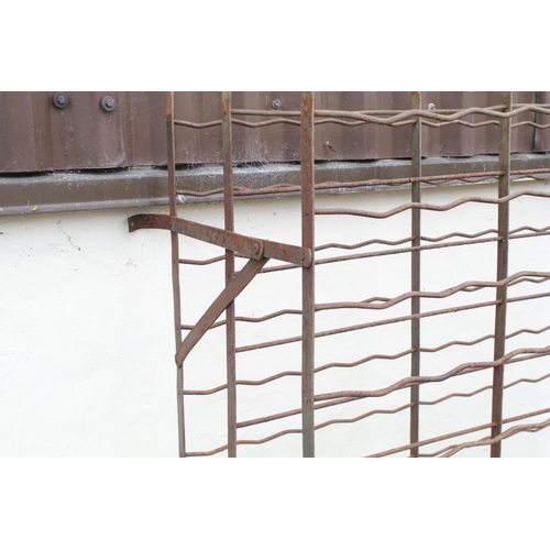 525 - Large wrought iron wall mounted wine rack, approx 154cm H x 101cm W x 49cm D