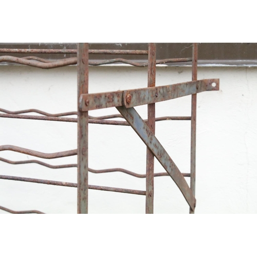 525 - Large wrought iron wall mounted wine rack, approx 154cm H x 101cm W x 49cm D